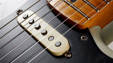 What are guitar pickups and why do they sometimes sound like a cat in a blender?